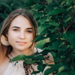 portrait-beautiful-blonde-girl-with-natural-beauty-green-leaves-trees-copy-empty-space-text_196938-3729